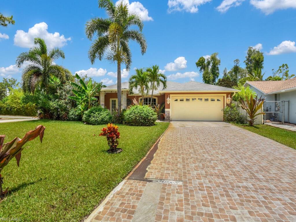 18363 Tulip Road Fort Myers, FL 33967 - Photo 1 of 23 a house with swimming pool in front of it