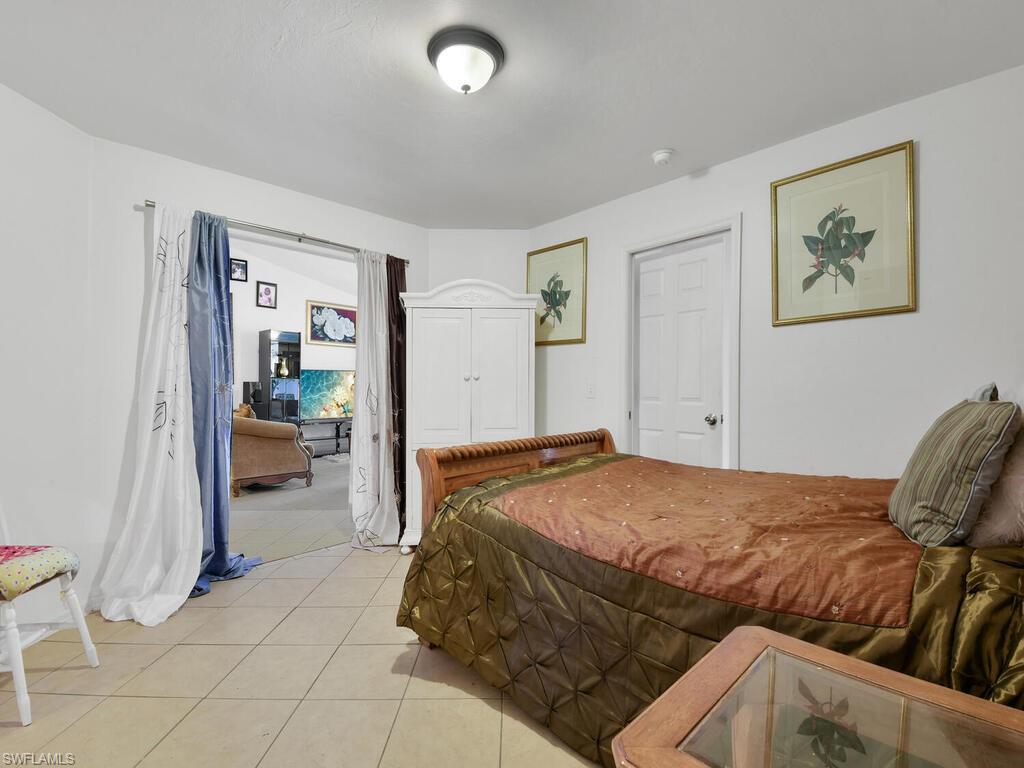 18363 Tulip Road Fort Myers, FL 33967 - Photo 11 of 23 a bedroom with a bed and a view of kitchen