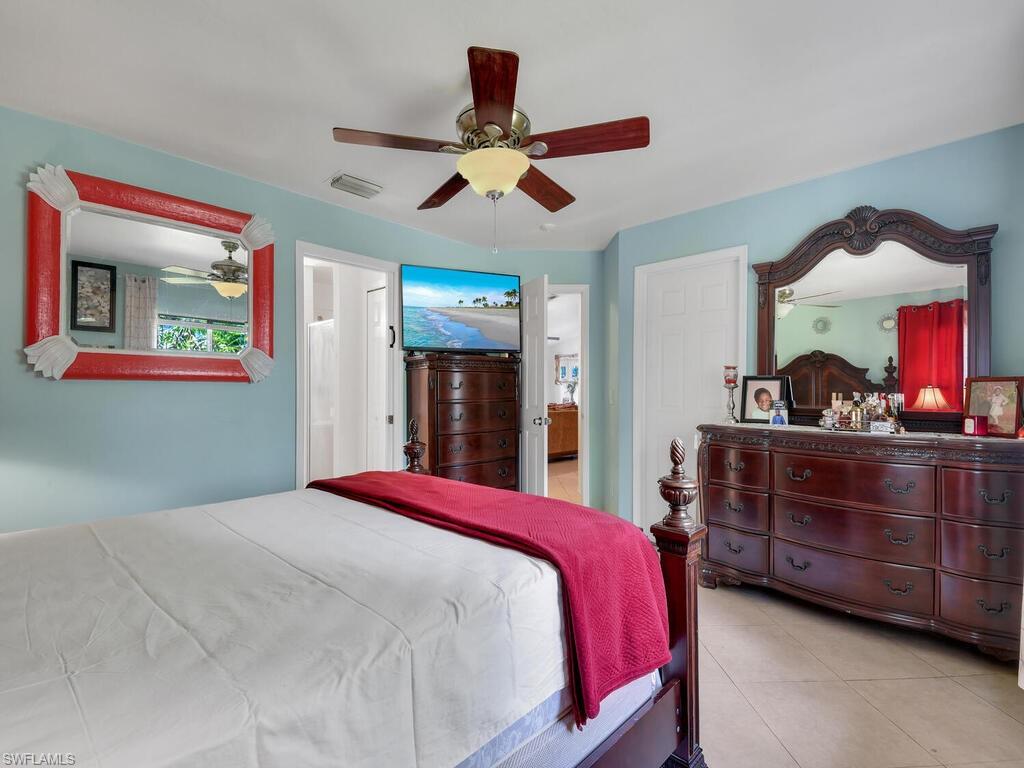 18363 Tulip Road Fort Myers, FL 33967 - Photo 13 of 23 a bed room with a bed and a dresser