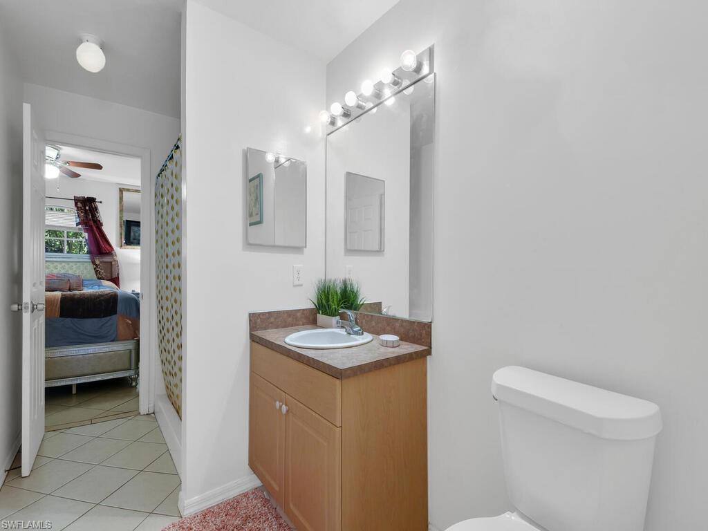18363 Tulip Road Fort Myers, FL 33967 - Photo 18 of 23 a bathroom with a sink a toilet and mirror