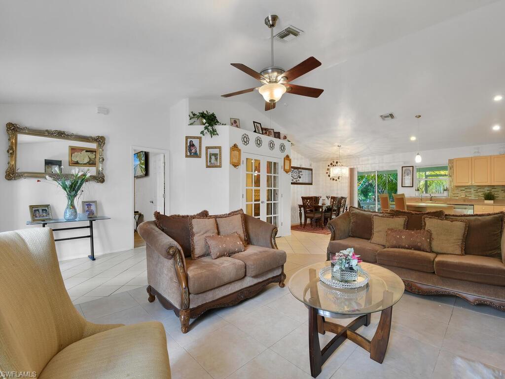 18363 Tulip Road Fort Myers, FL 33967 - Photo 3 of 23 a living room with furniture kitchen view and a chandelier