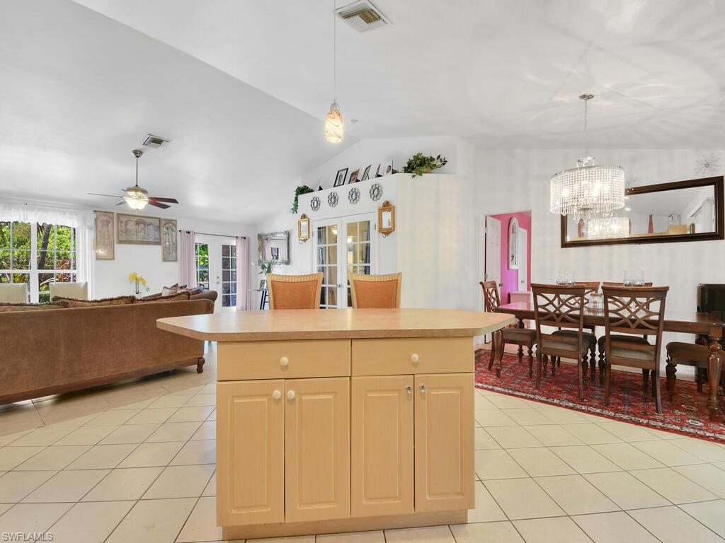 18363 Tulip Road Fort Myers, FL 33967 - Photo 5 of 23 a kitchen with cabinets and chairs in it