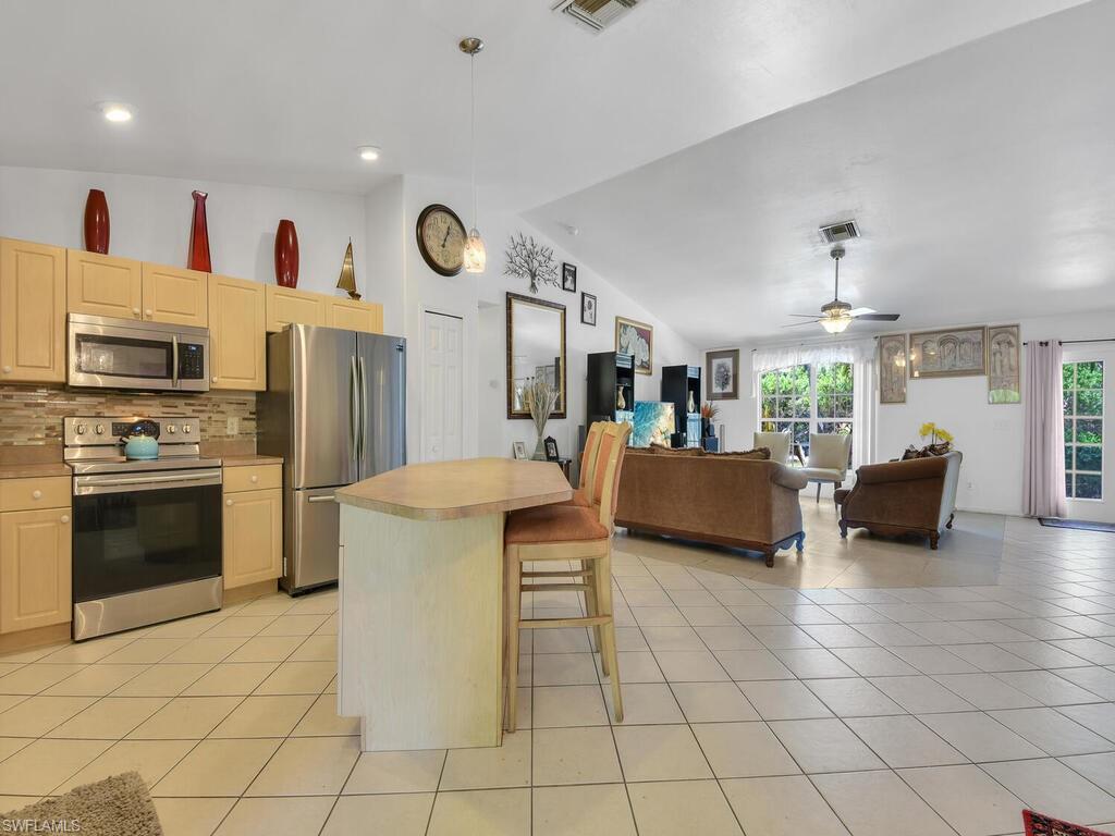 18363 Tulip Road Fort Myers, FL 33967 - Photo 6 of 23 a kitchen with furniture and a fireplace