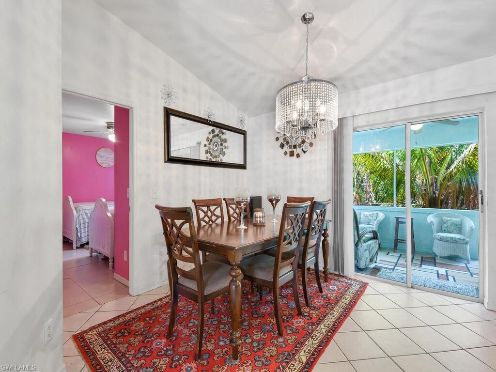 18363 Tulip Road Fort Myers, FL 33967 - Photo 7 of 23 a dining room with furniture a chandelier and window