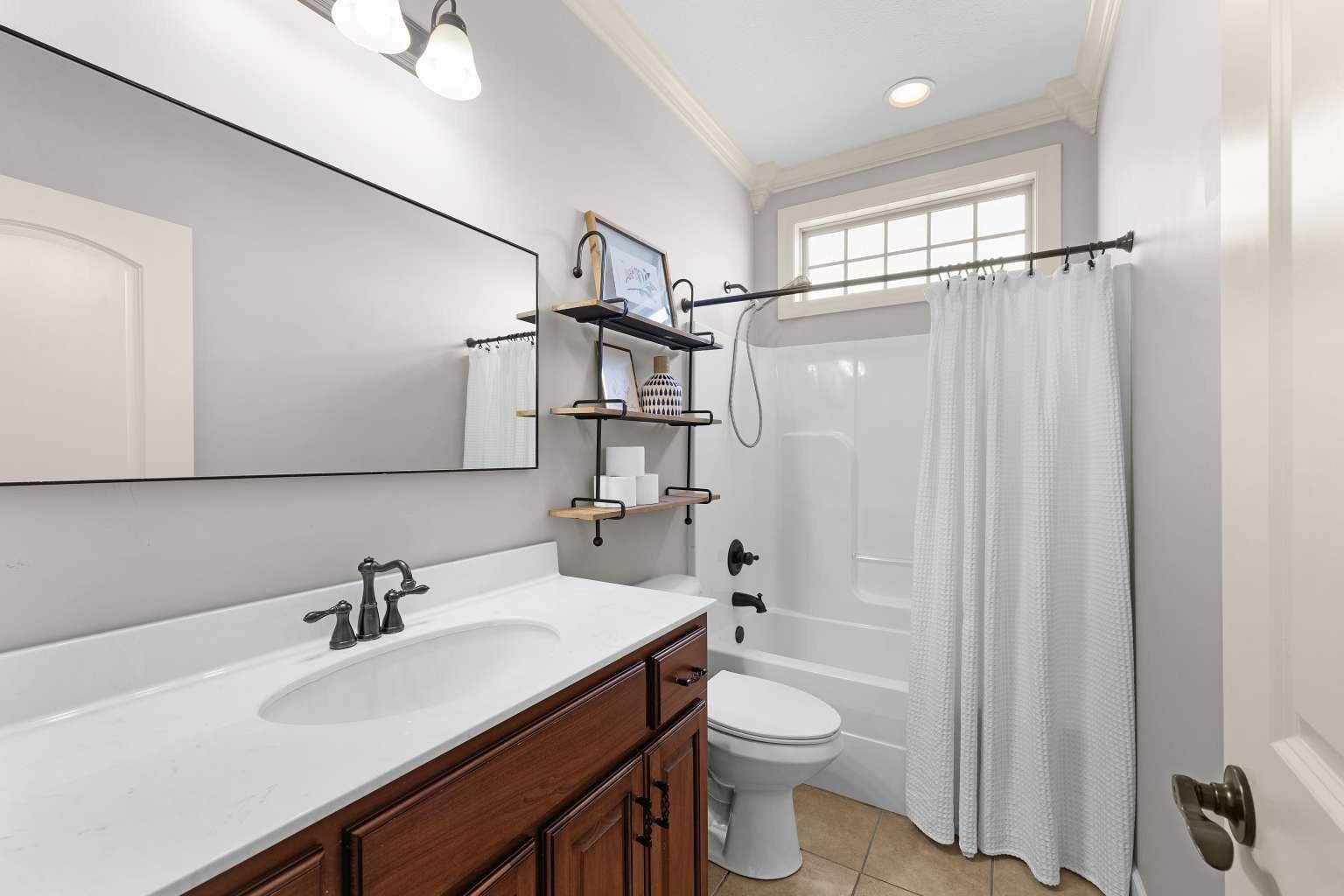 621 Wortham Cemetery Road Bells, TN 38006 - Photo 14 of 25 Bathroom with vanity, ornamental molding, light tile patterned floors, and shower / bath combination with curtain