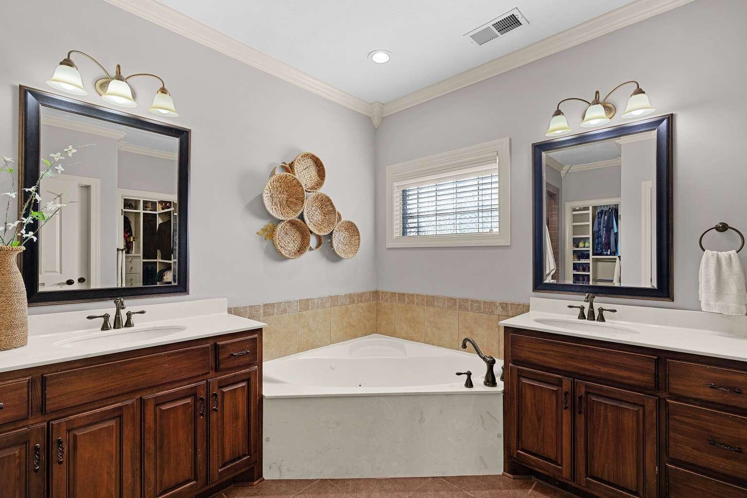 621 Wortham Cemetery Road Bells, TN 38006 - Photo 19 of 25 Bathroom with two vanities, ornamental molding, a bath, and light tile patterned flooring