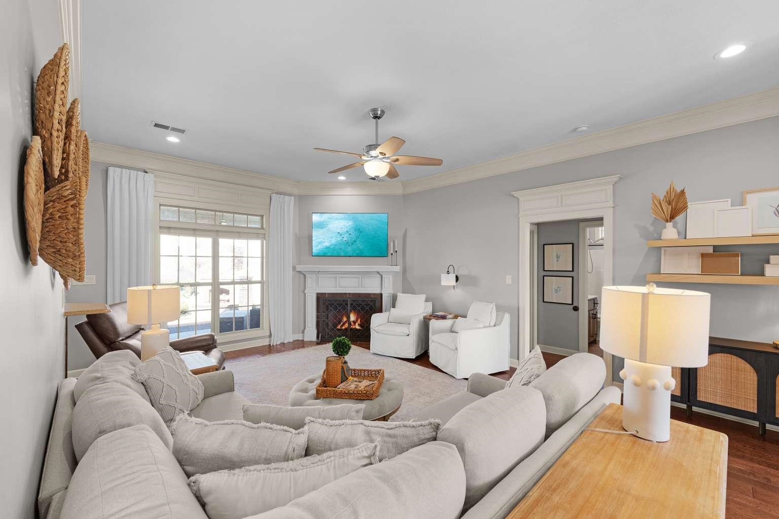 621 Wortham Cemetery Road Bells, TN 38006 - Photo 7 of 25 Living area featuring crown molding, a ceiling fan, a lit fireplace, recessed lighting, and wood finished floors
