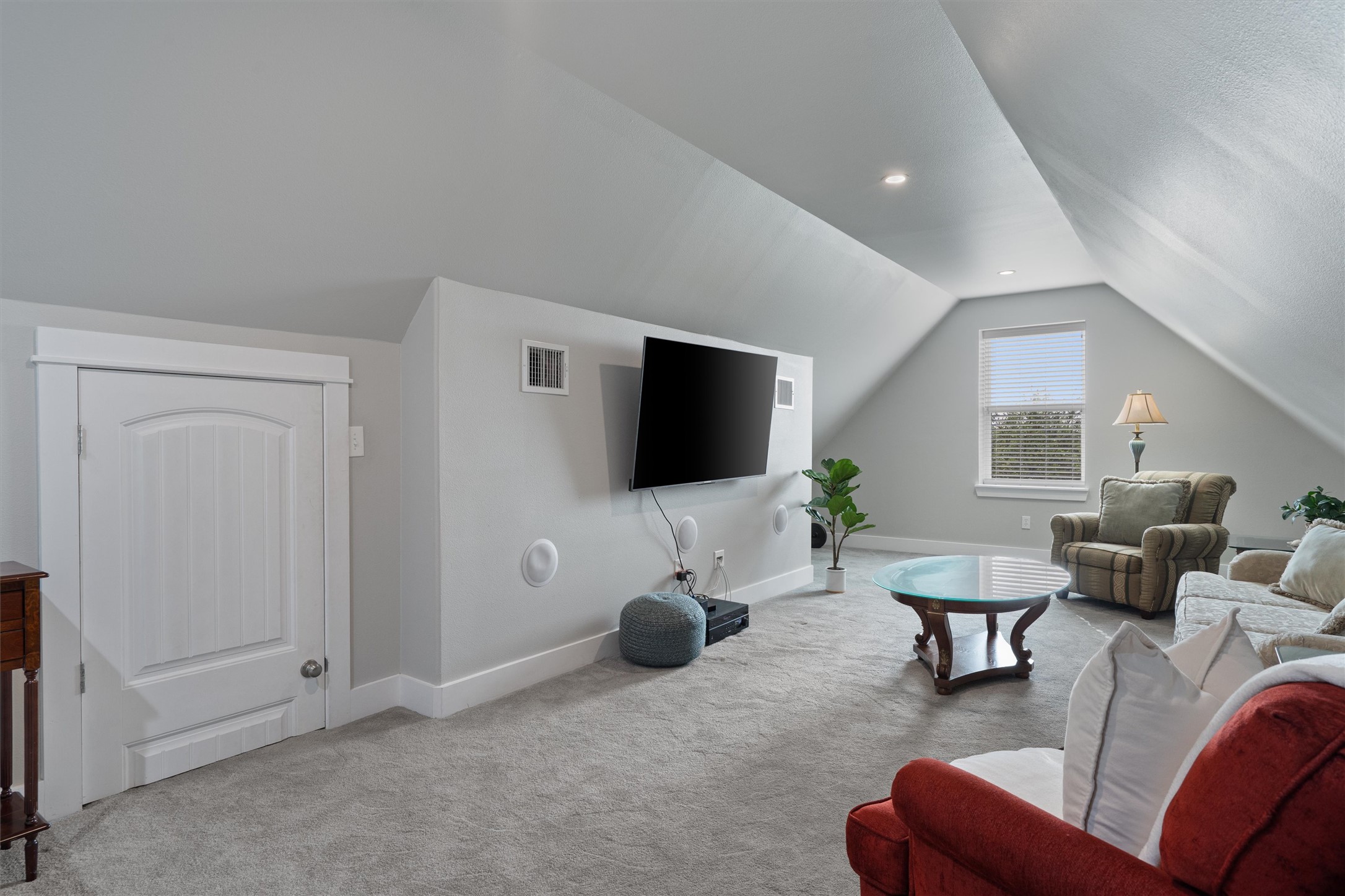 13105 Rooster Springs Road Austin, TX 78737 - Photo 20 of 38 This versatile living area features sloped ceilings, recessed lighting, and a window with blinds providing natural illumination