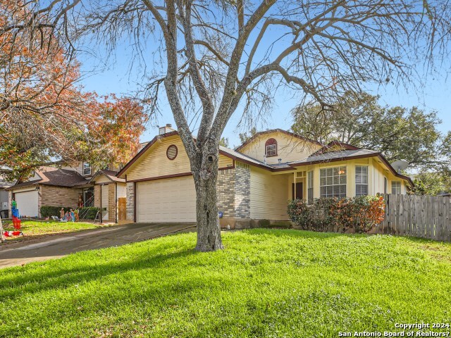 9230 Ridge Breeze San Antonio, TX 78250 - Photo 1 of 1 a front view of a house with garden