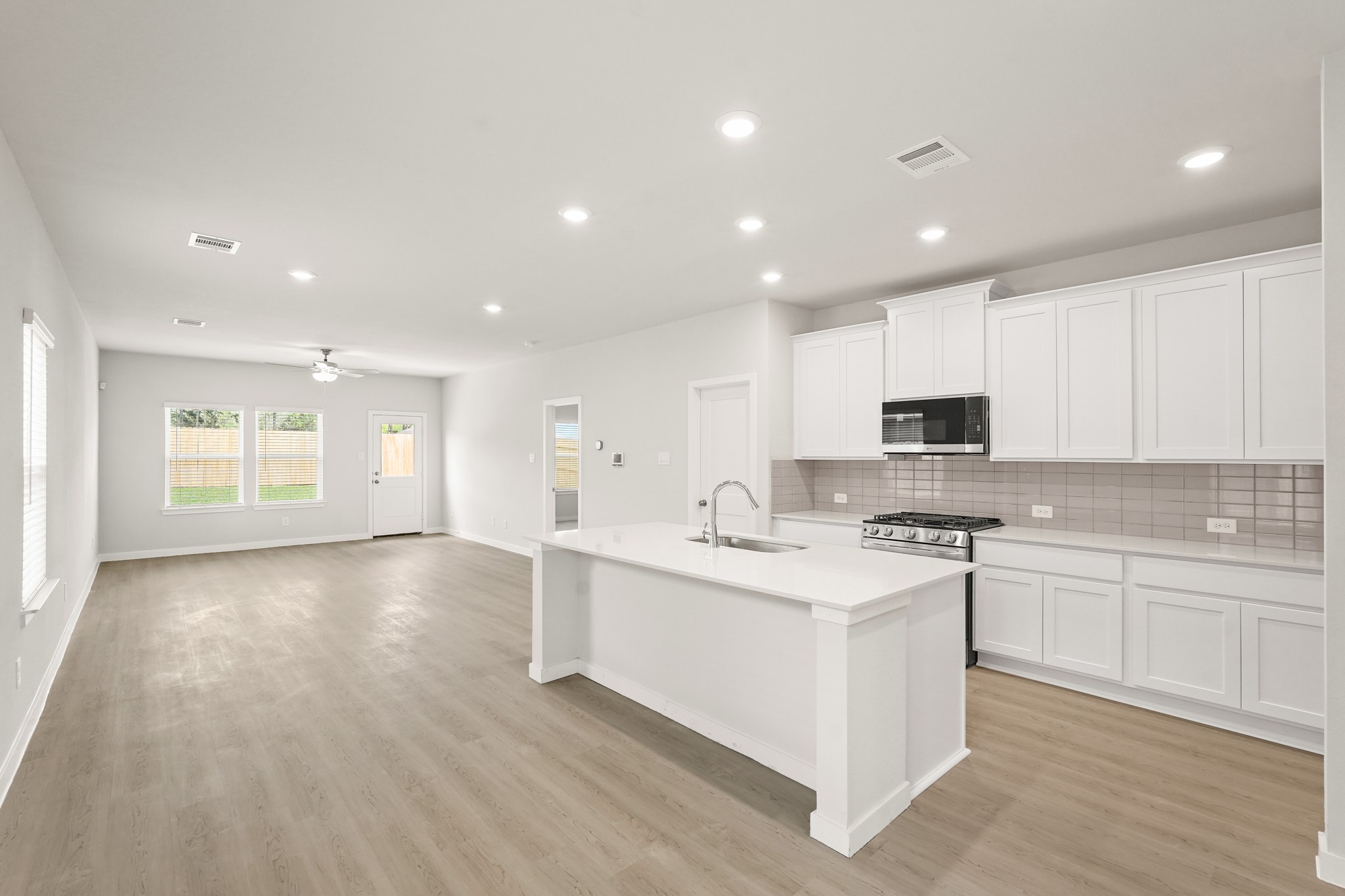 113 Rising Cedar Lane Hockley, TX 77447 - Photo 4 of 27 a large kitchen with stainless steel appliances granite countertop a stove and a sink