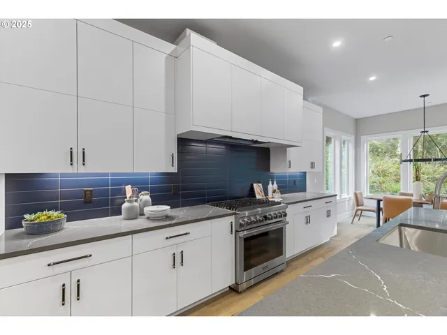 a kitchen with granite countertop a sink stainless steel appliances and cabinets