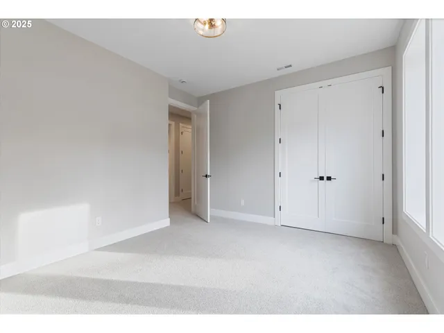 a bathroom with a granite countertop sink a light fixture and a mirror