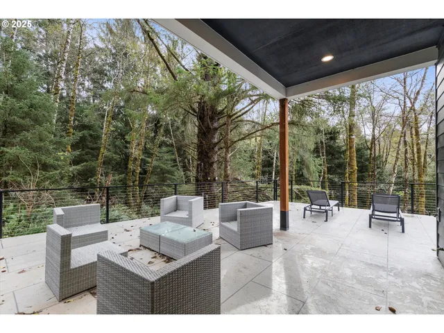 a view of a patio with couches table and chairs and potted plants