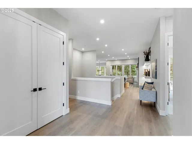 a view of a living room and kitchen with furniture appliances
