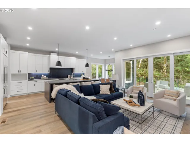 a living room with furniture wooden floor and a large window