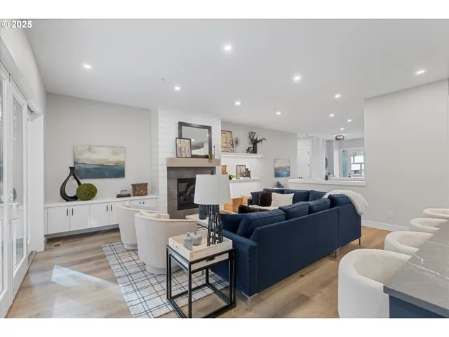 a living room with furniture a fireplace and a kitchen view