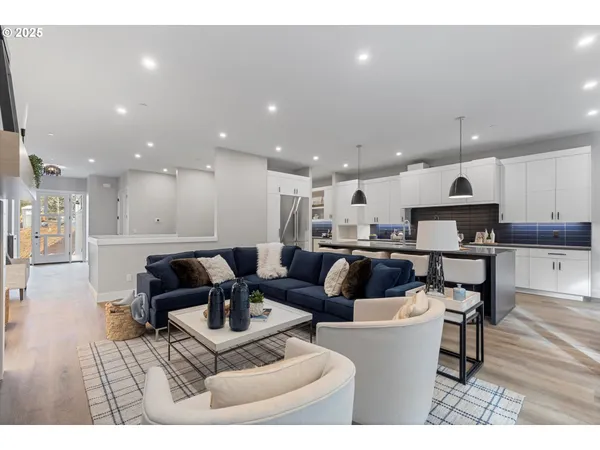 a living room with furniture and kitchen view