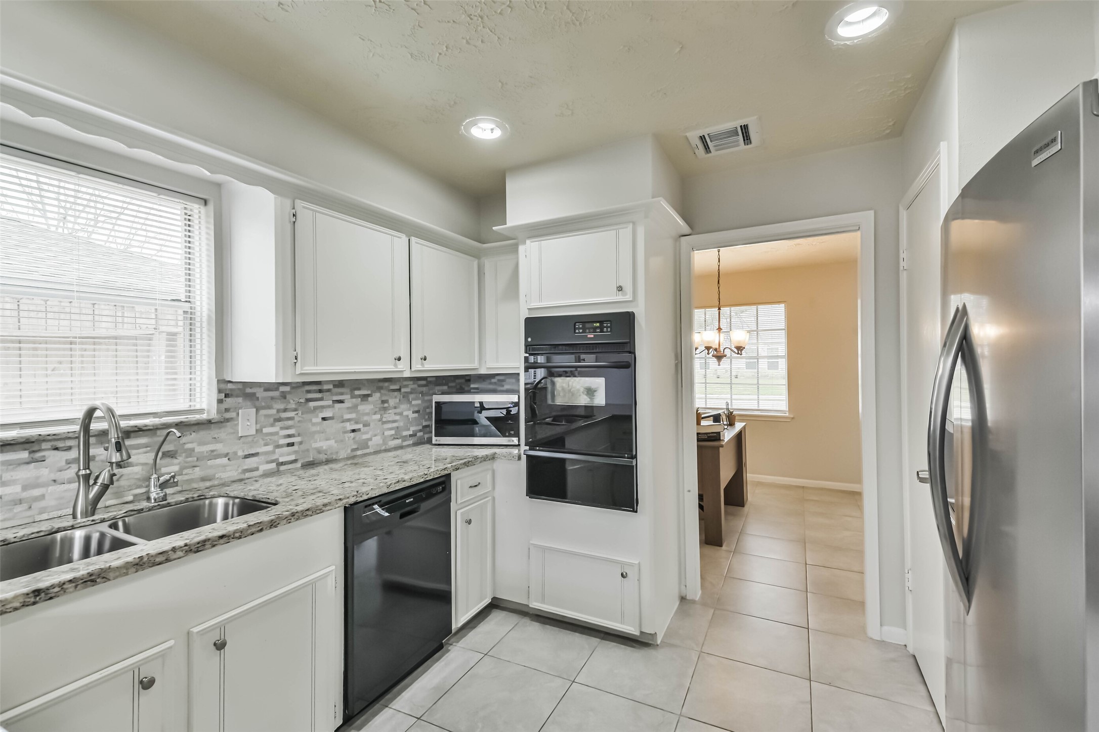 9614 Ballin David Drive Spring, TX 77379 - Photo 16 of 40 a kitchen with a sink stove and refrigerator