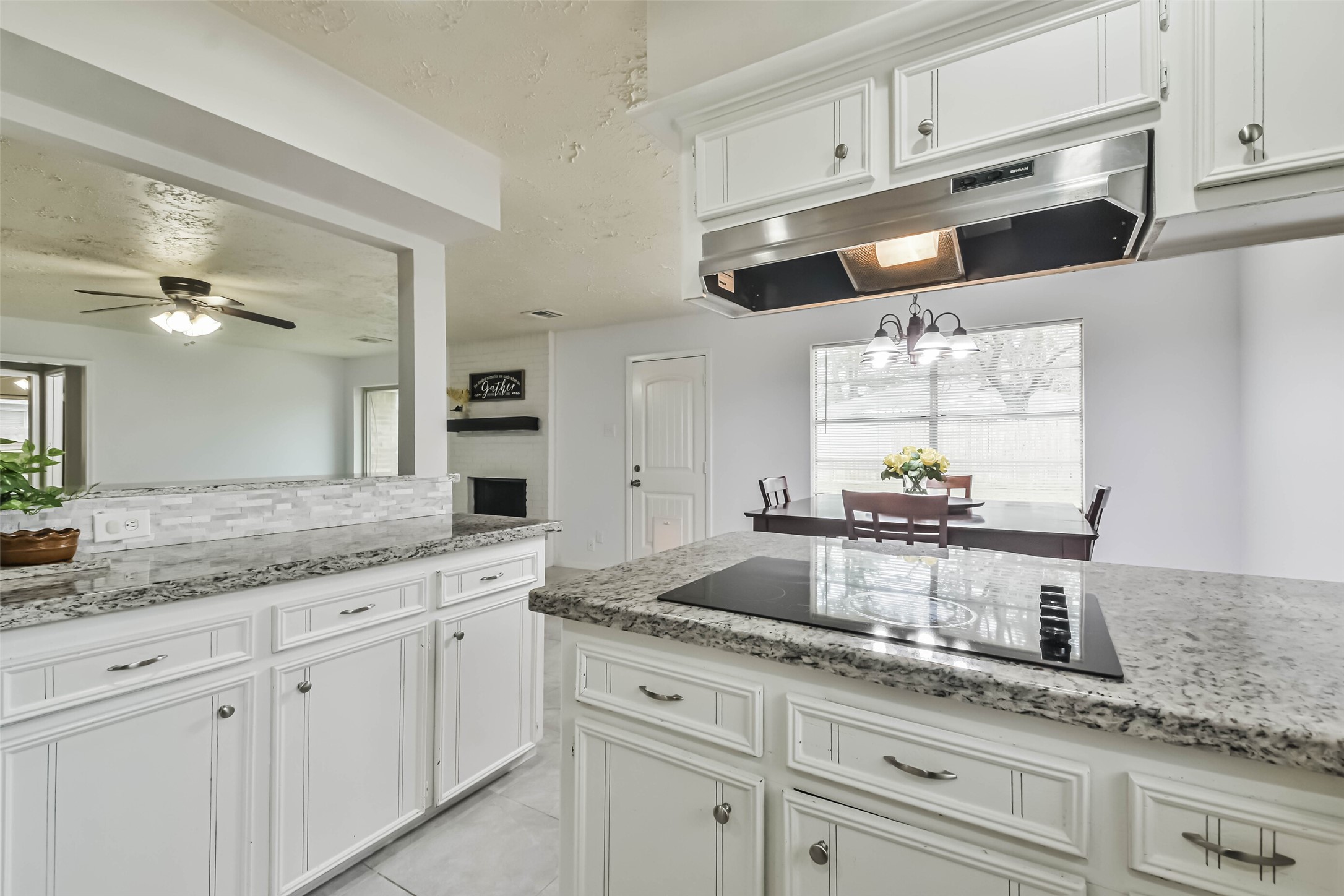 9614 Ballin David Drive Spring, TX 77379 - Photo 18 of 40 a kitchen with granite countertop white cabinets white appliances and a granite counter tops