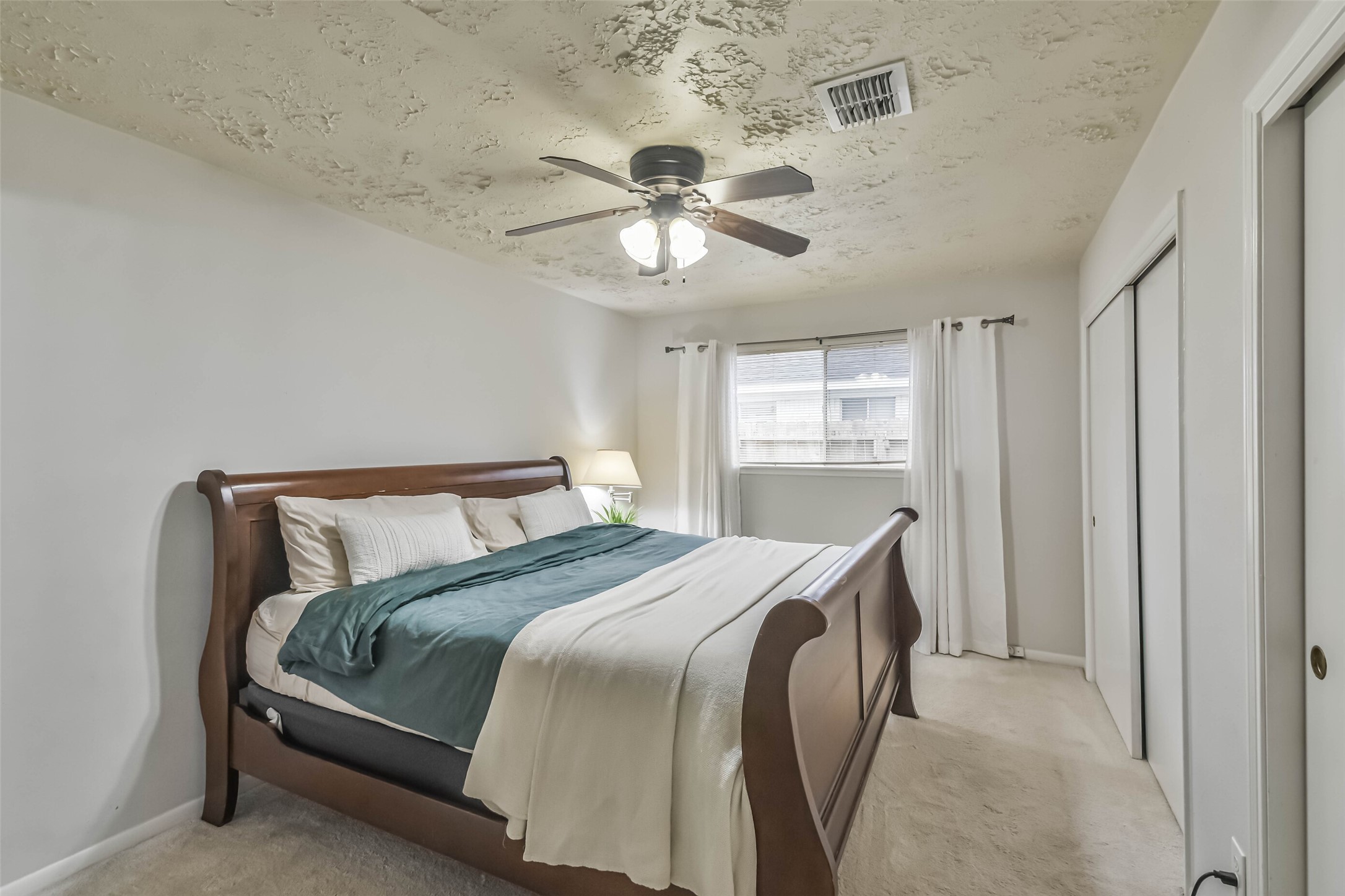 9614 Ballin David Drive Spring, TX 77379 - Photo 21 of 40 a bedroom with a bed and a chandelier