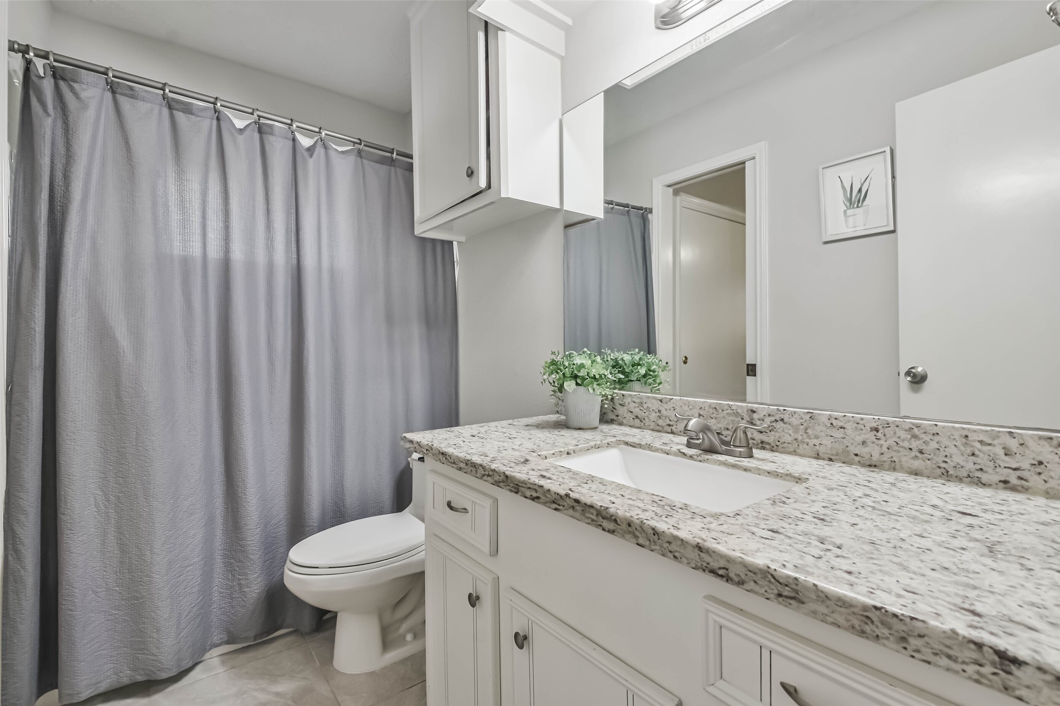 9614 Ballin David Drive Spring, TX 77379 - Photo 23 of 40 a bathroom with a granite countertop sink and a mirror