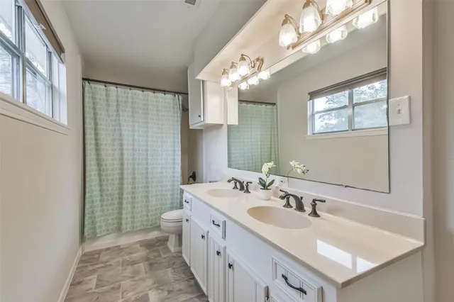 a bathroom with a sink double vanity and a shower