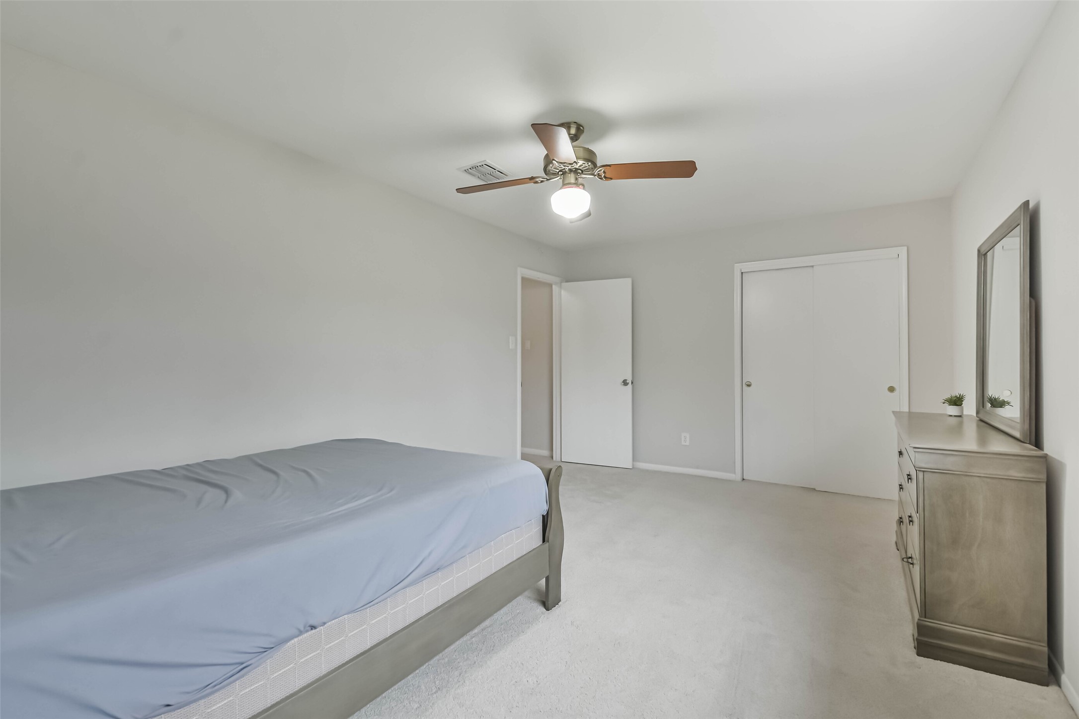 9614 Ballin David Drive Spring, TX 77379 - Photo 28 of 40 a bedroom with a bed and cabinets