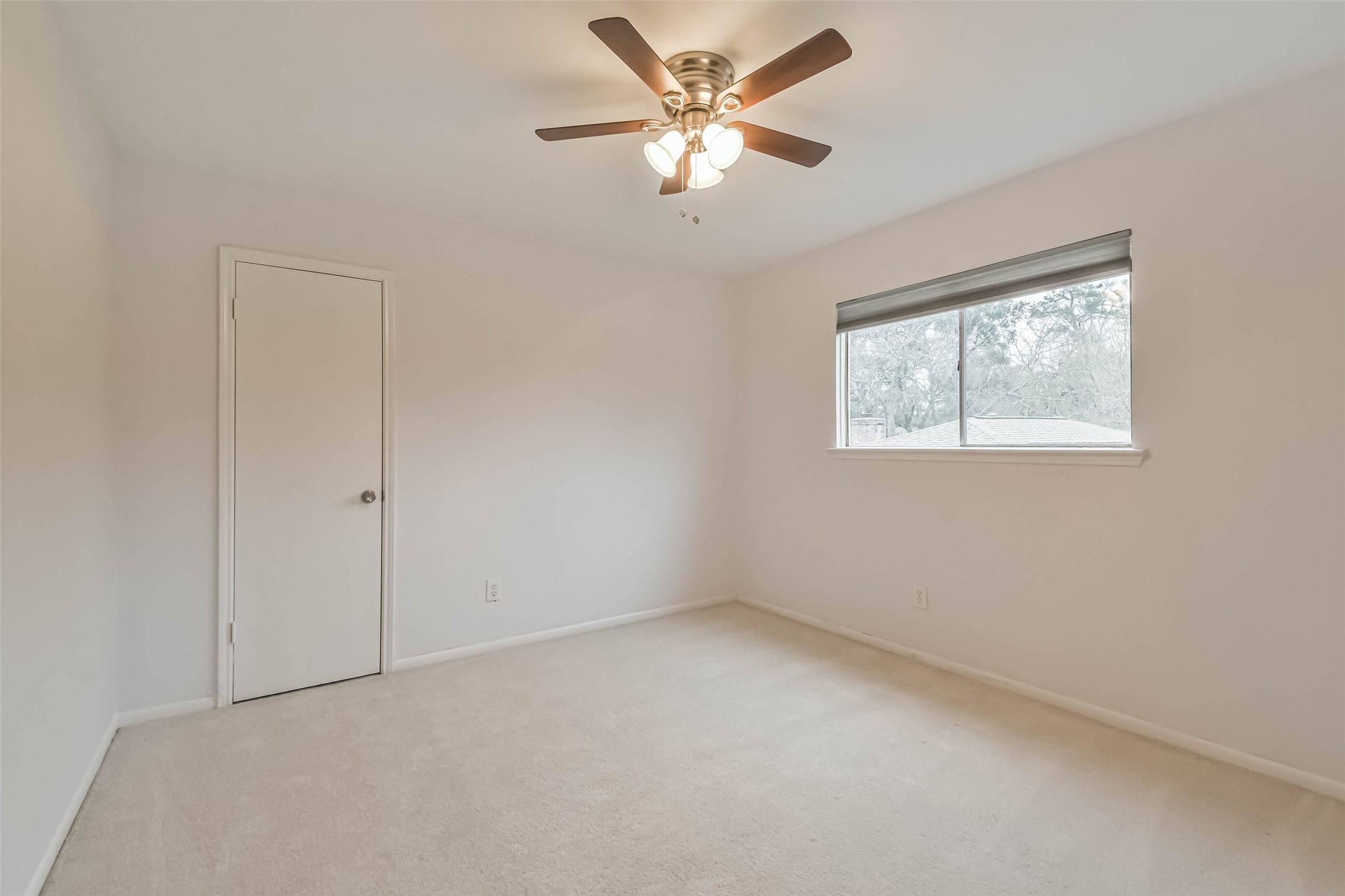9614 Ballin David Drive Spring, TX 77379 - Photo 29 of 40 an empty room with a window and a fan