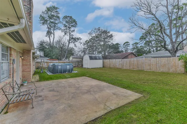 a view of a backyard with a slide and a tree