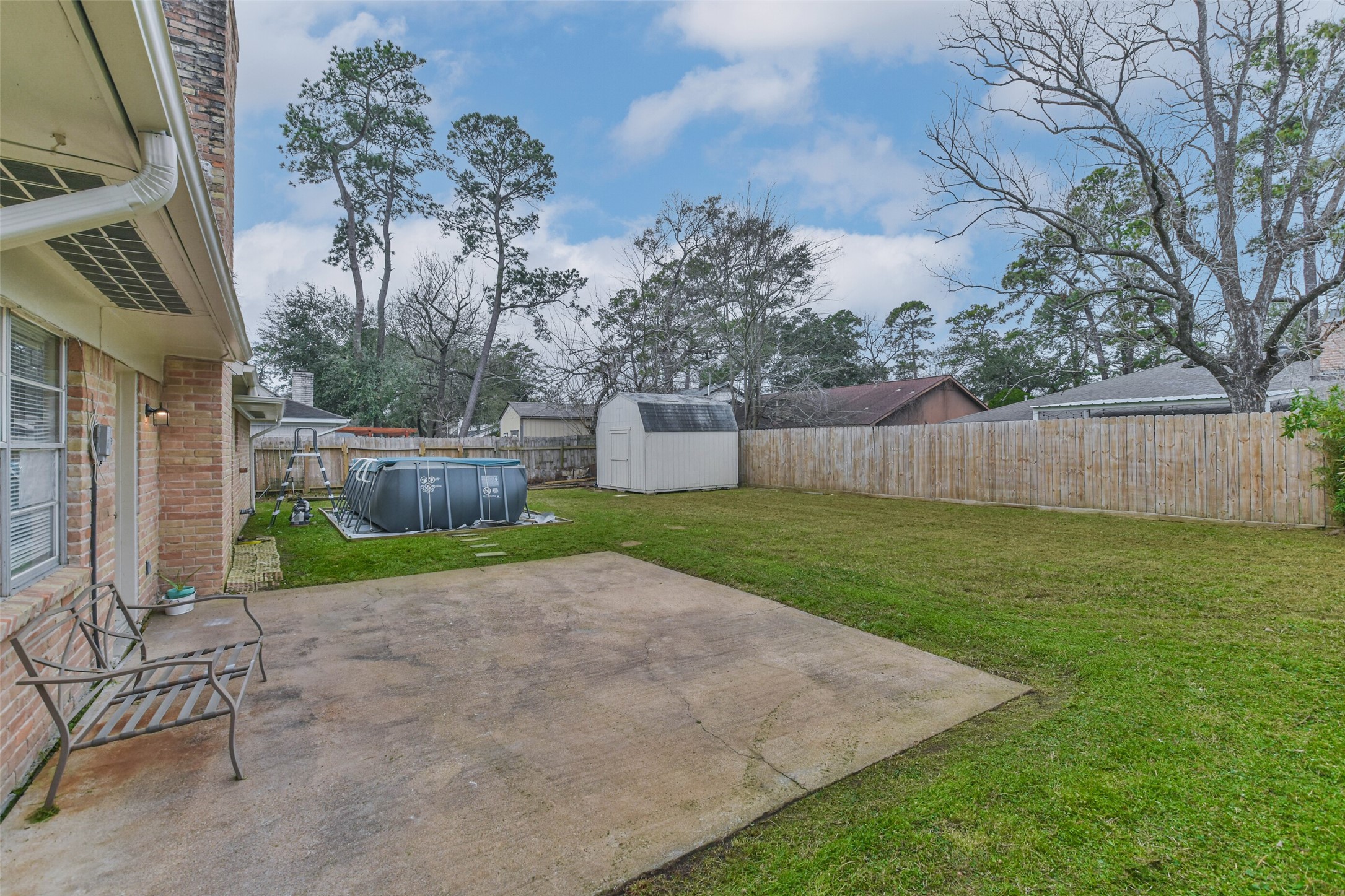 9614 Ballin David Drive Spring, TX 77379 - Photo 31 of 40 a view of a backyard with a slide and a tree