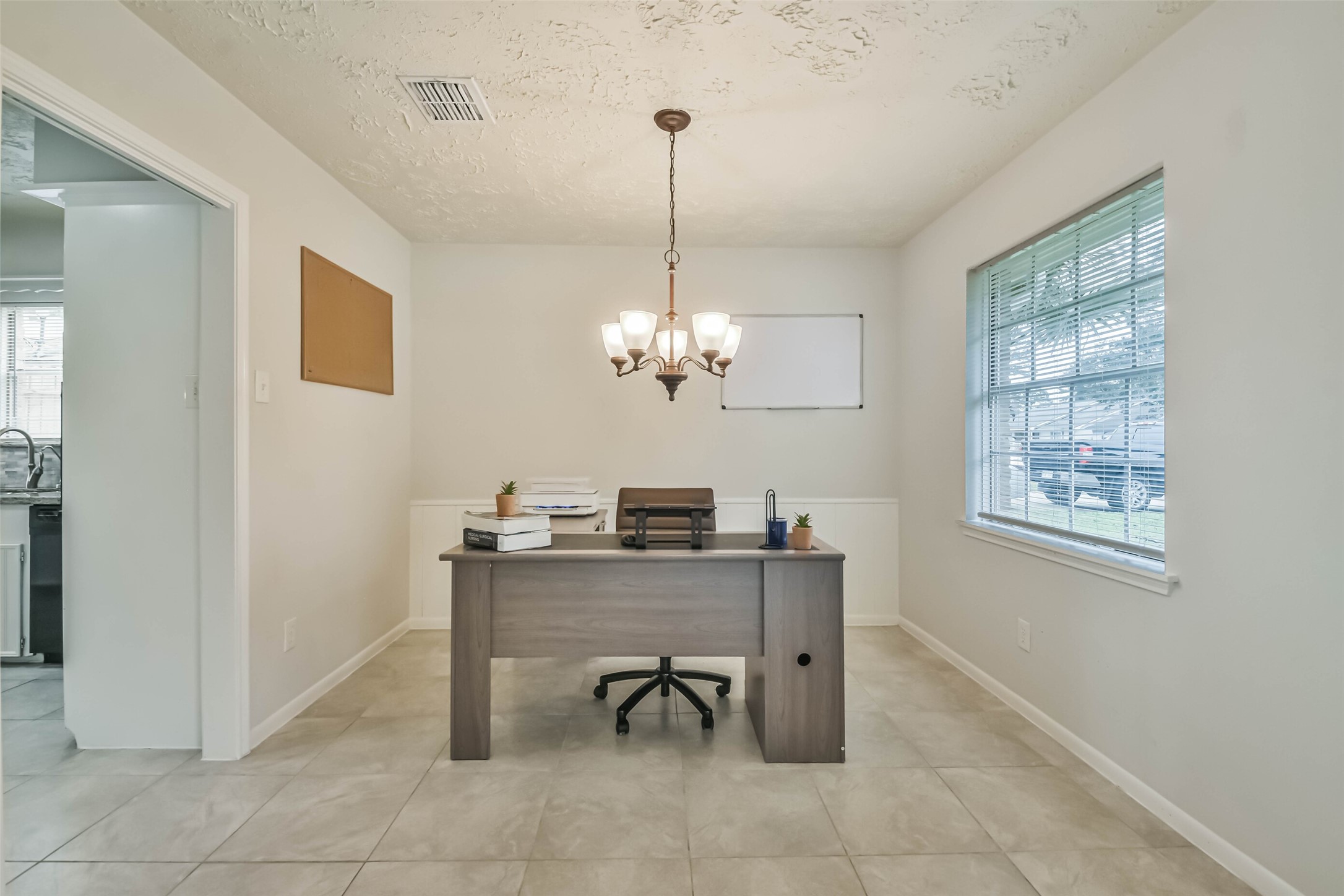 9614 Ballin David Drive Spring, TX 77379 - Photo 8 of 40 a view of a workspace with furniture and a chandelier