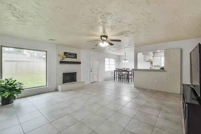 a view of a livingroom with a kitchen and a stove top oven