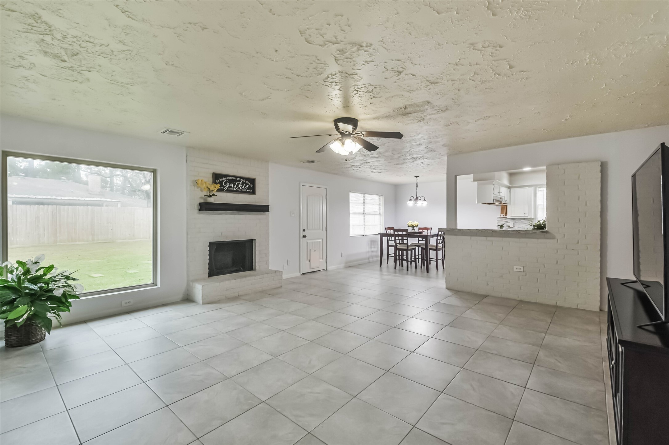9614 Ballin David Drive Spring, TX 77379 - Photo 10 of 40 a view of a livingroom with a kitchen and a stove top oven