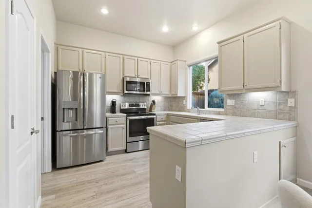 a kitchen with a sink stove and cabinets