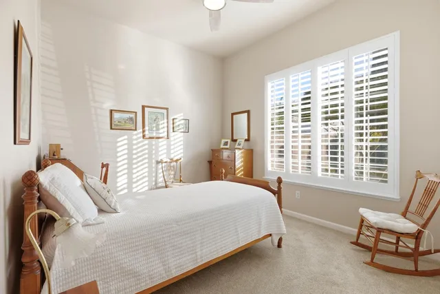 a bathroom with a double vanity sink toilet mirror and shower