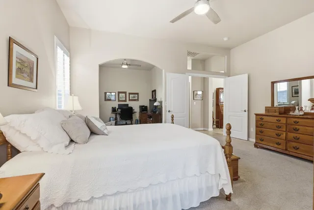 a view of a livingroom with workspace and a window