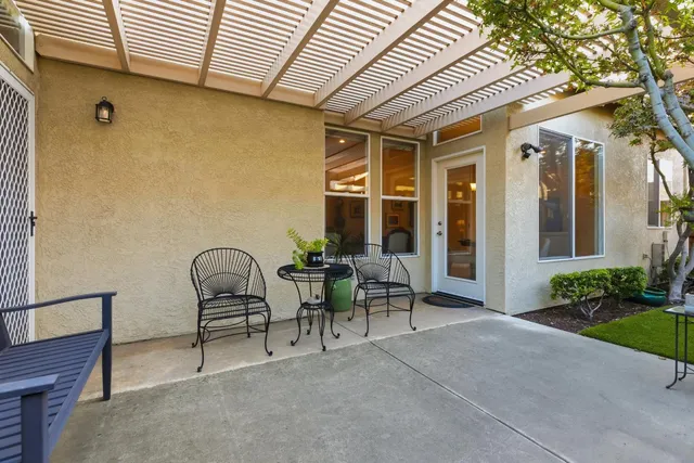 a view of a pathway with a potted plant in front of a door