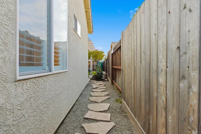 a front view of a house with a garden and plants