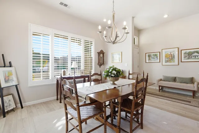 a living room with furniture a fireplace and a large window