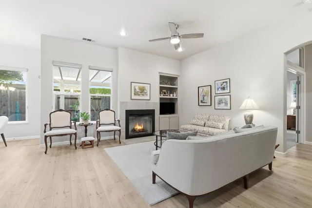 a living room with furniture and wooden floor