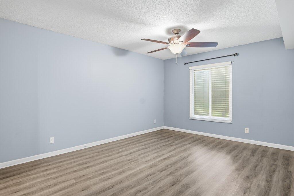 2500 Southeast Anchorage Cove, Unit B2 Port St. Lucie, FL 34952 - Photo 13 of 25 a view of an empty room with wooden floor and a window
