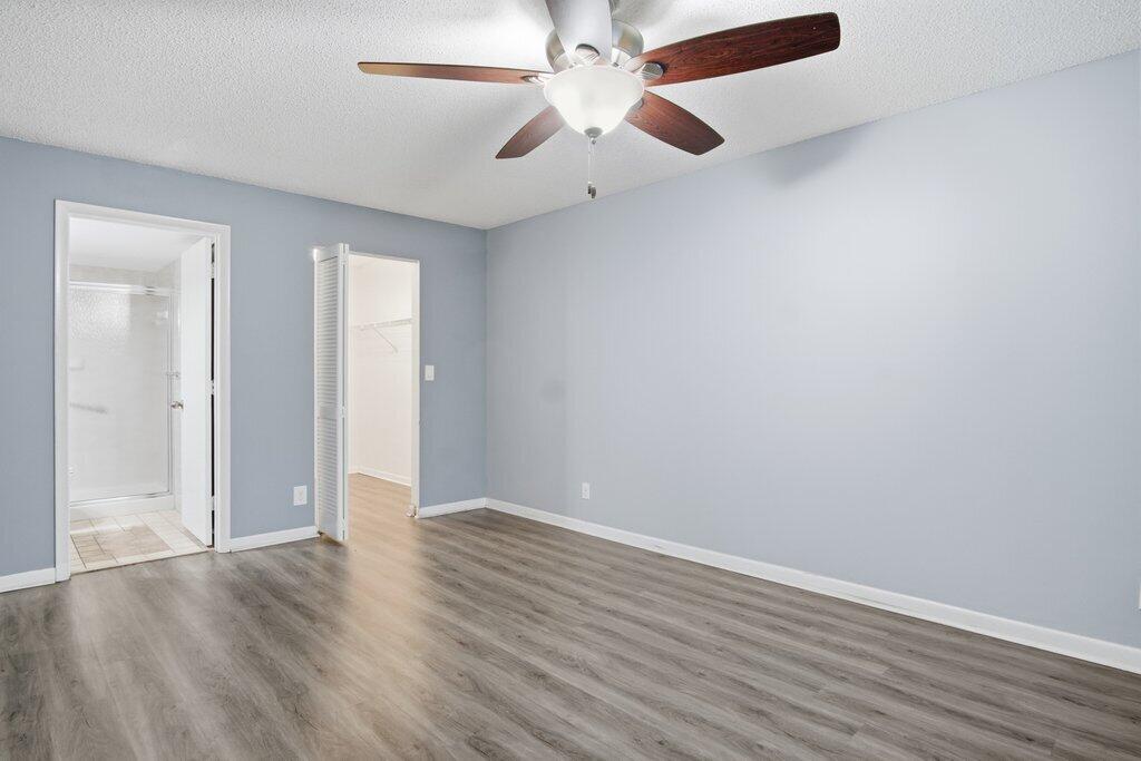 2500 Southeast Anchorage Cove, Unit B2 Port St. Lucie, FL 34952 - Photo 14 of 25 an empty room with wooden floor a ceiling fan and closet