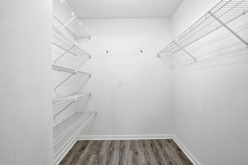 2500 Southeast Anchorage Cove, Unit B2 Port St. Lucie, FL 34952 - Photo 16 of 25 a view of walk in closet with racks on the wall