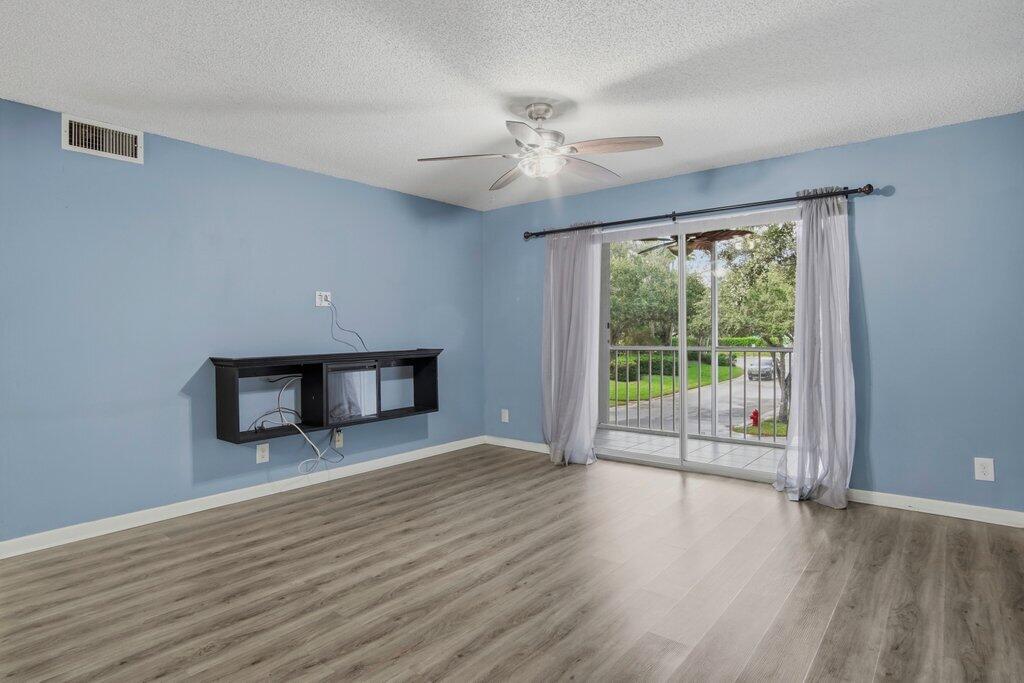 2500 Southeast Anchorage Cove, Unit B2 Port St. Lucie, FL 34952 - Photo 2 of 25 a view of a livingroom with wooden floor fan and a window