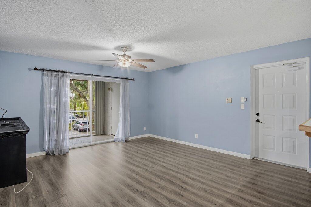 2500 Southeast Anchorage Cove, Unit B2 Port St. Lucie, FL 34952 - Photo 3 of 25 a view of an empty room with a window and wooden floor