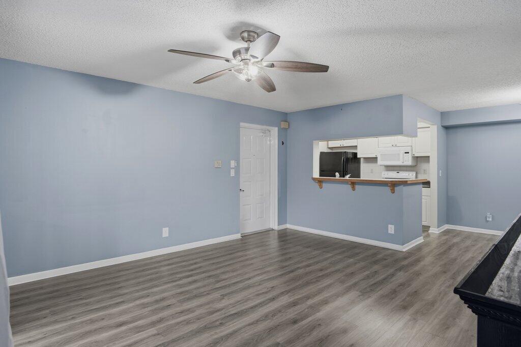 2500 Southeast Anchorage Cove, Unit B2 Port St. Lucie, FL 34952 - Photo 5 of 25 a view of kitchen with wooden floor and window