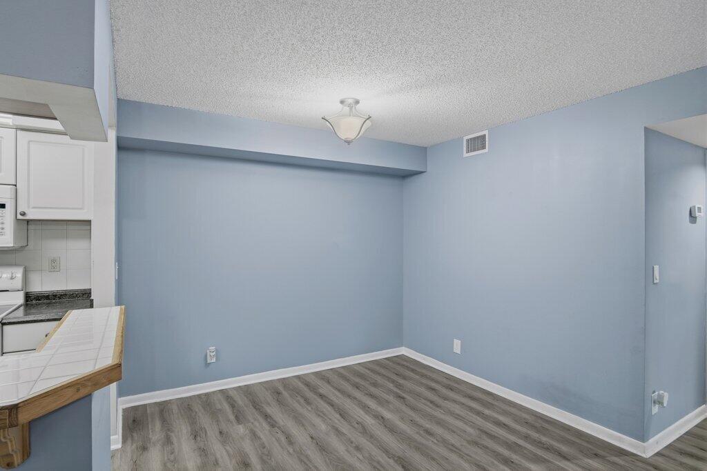 2500 Southeast Anchorage Cove, Unit B2 Port St. Lucie, FL 34952 - Photo 6 of 25 a view of a kitchen with wooden floor and a sink