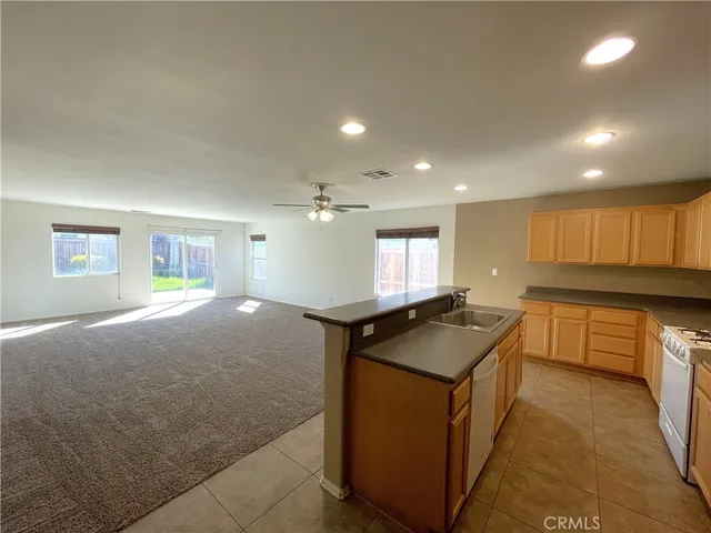 a kitchen with stainless steel appliances granite countertop a sink and a stove