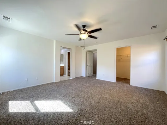 a view of a livingroom with a ceiling fan and hardwood floor
