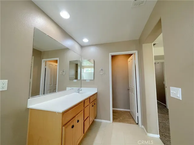 a bathroom with a sink a vanity and a mirror
